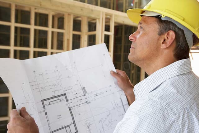 Builder reviewing construction plans