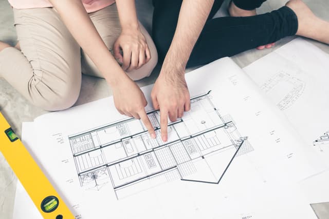 Family looking at house plans together