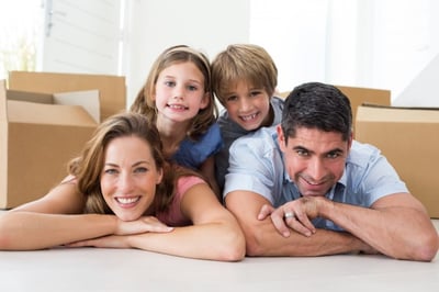 Portrait of happy family lying on floor in their new house