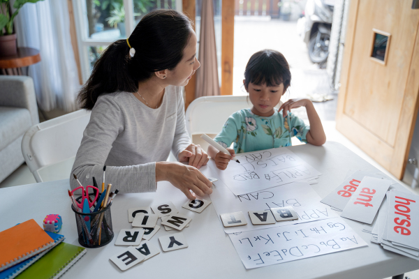 Mother and son homeschooling at a table