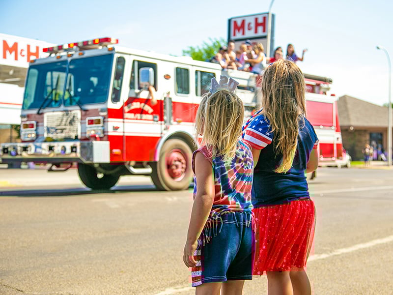 Children watching Fourth of July parade in Blanchard Oklahoma with firetruck passing by