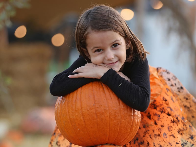 Child enjoying pumpkin patch at Orr Family Farm near Goldsby Oklahoma