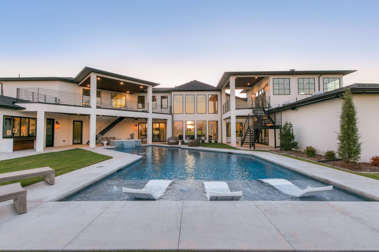 Exterior of large two-story home with swimming pool in backyard